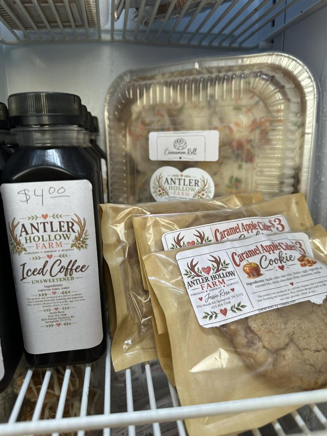 Antler Hollow Farm caramel apple cider cookies beside a bottle of iced coffee and a tray of cinnamon rolls.